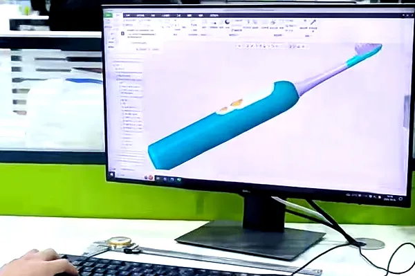 Engineers conducting structural verification and 3D modeling review for electric toothbrush manufacturability.