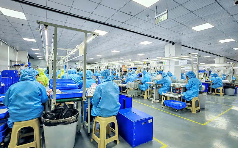 Relish manufacturing team working in a clean, well-lit assembly line, reflecting a respectful and supportive workplace environment.