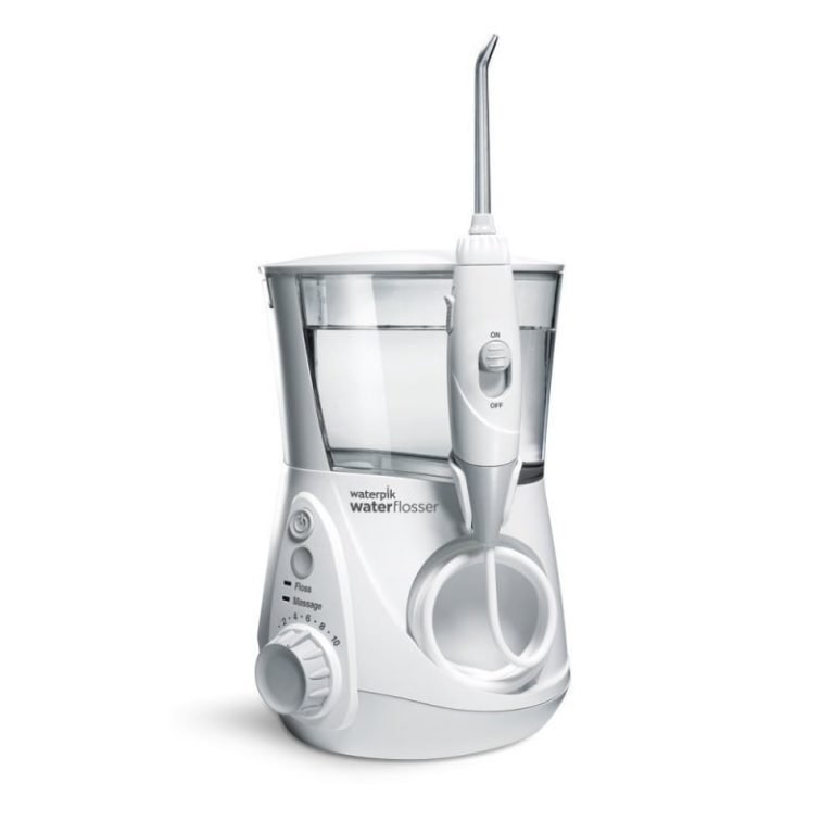 White Waterpik countertop water flosser with reservoir and a handle connected by a hose.