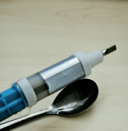 Demonstration of a metal spoon attracted to a toothbrush drive housing.