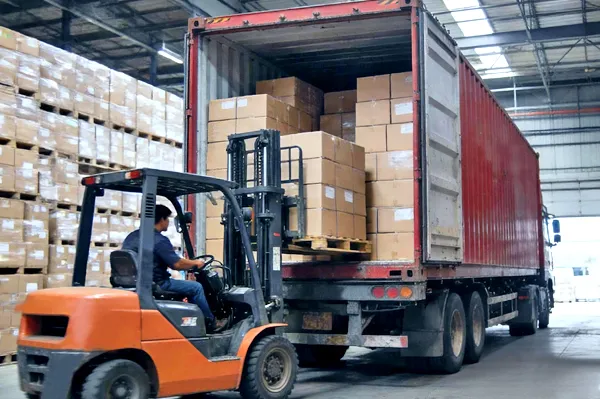 Global logistics and delivery: Forklift loading fully packaged OEM electric toothbrush orders into a shipping container.